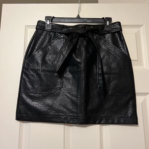 Black faux snakeskin leather skirt with pockets and a tied belt
